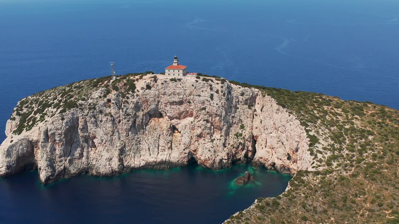 Susac Lighthouse Over Steep Rock Cliffs Of Susac Islet Near Lastovo, Croatia. Aerial Shot