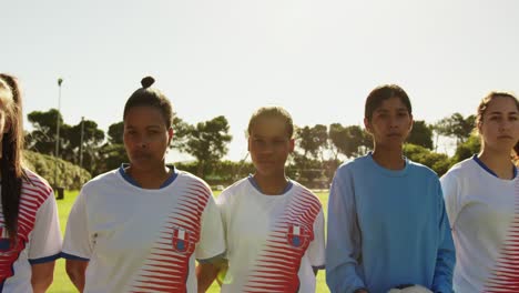 Female-soccer-team-standing-next-to-each-other-on-soccer-field.-4k