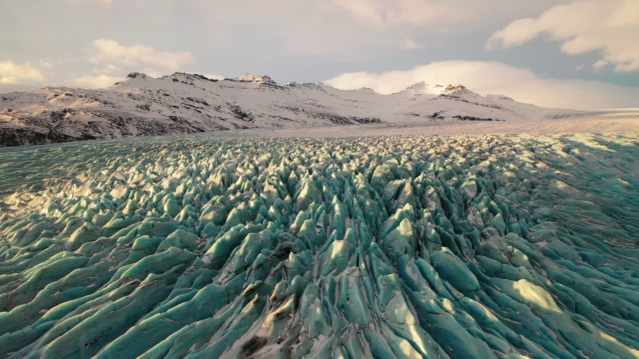 The beautiful Falljokull glacier outlet in South Iceland during the sunset - low aerial
