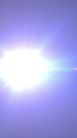 animation of spotlight with lens flare and light beams moving over dark background