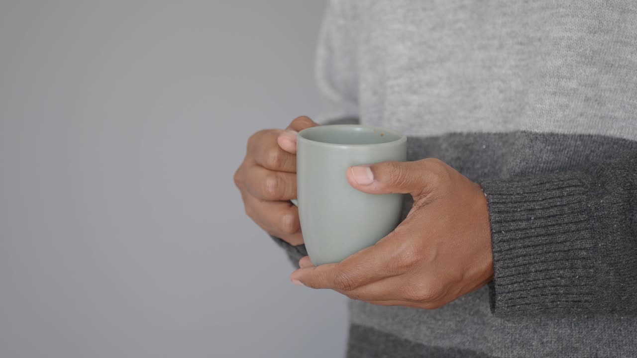 Person holding a mug of warm drink