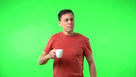 man reacts with disgust and surprise after drinking on green screen