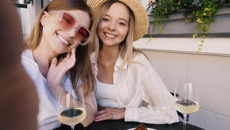 happy friends taking selfie in a cafe