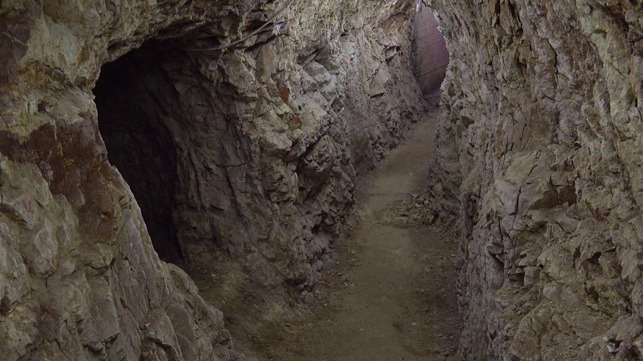 Narrow Passage Inside an Abandoned Underground Mine Tunnel