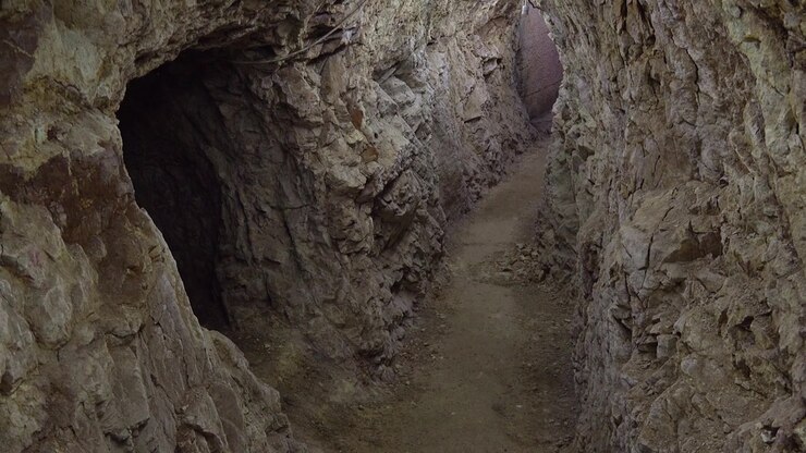 Narrow Passage Inside an Abandoned Underground Mine Tunnel