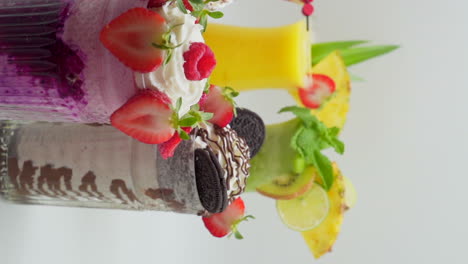 cocktails decorated with fruits and milk shakes of various flavors on a white background