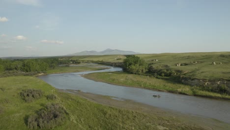 drone-aerial-of-family-sailing-down-river-in-Alberta-Canada