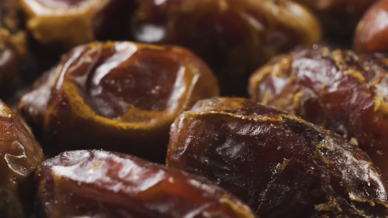 Dried date palm on a rotating table. Snack food macro shot. Slowly spin around in pattern.