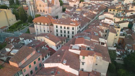 drone dolley shot over the inner city of florence illuminated by the setting sun