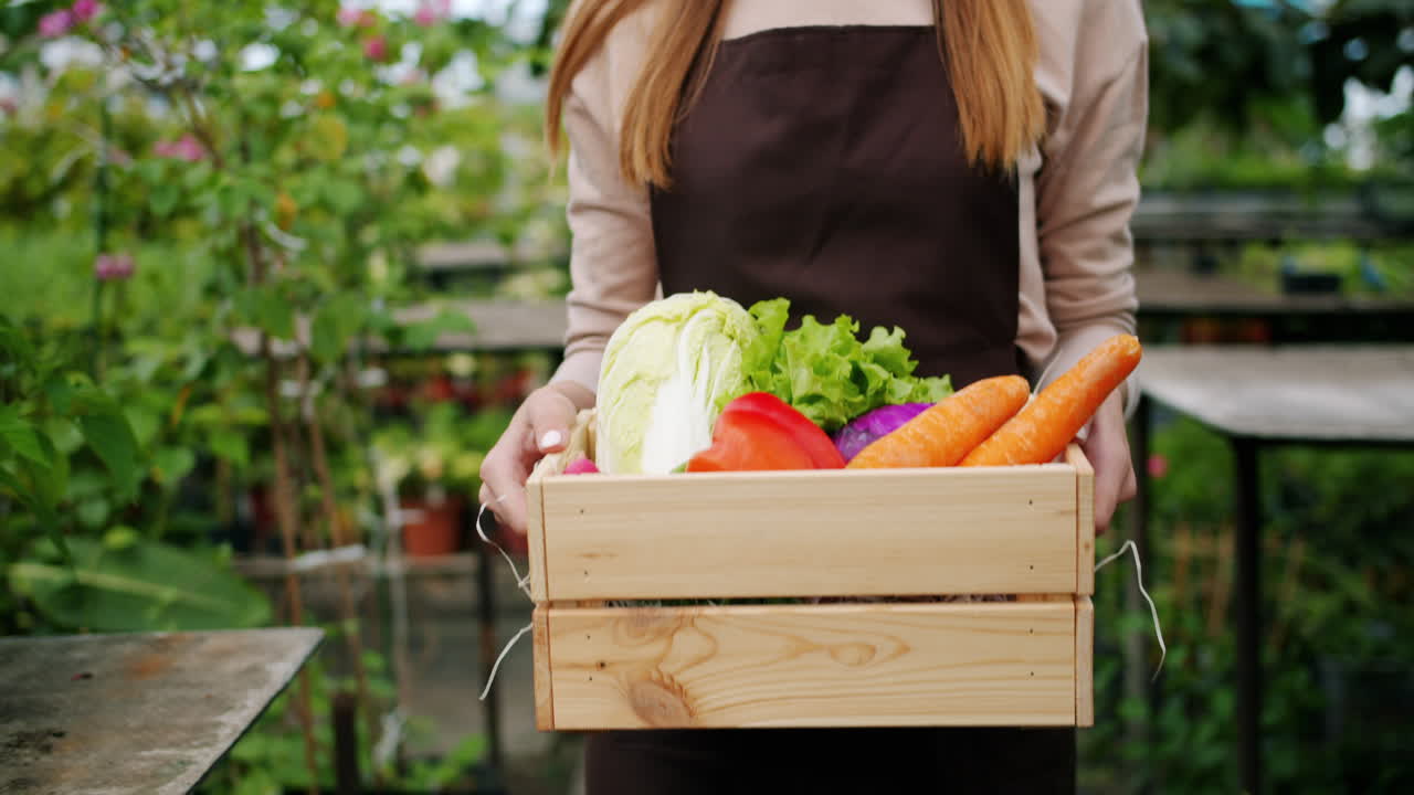 Woman Farmer in Greenhouse with Fresh Produce