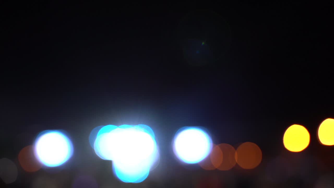 Blurred bokeh traffic on the road at night in a big city,