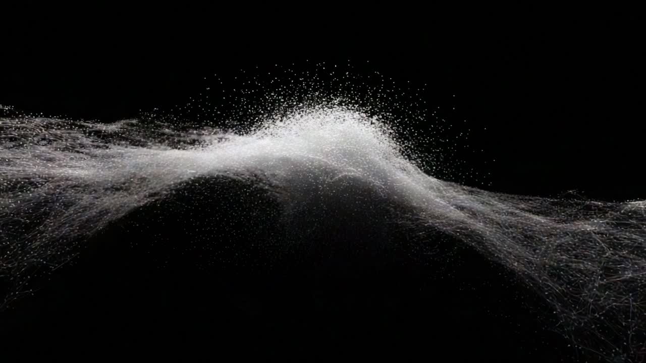 A Stunning Visual Display of Water Particles Creating Dynamic Waveforms Against a Black Background, Capturing the Beauty of Fluid Dynamics and Motion in Artful Photography