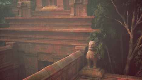 statue of person on ledge near tree