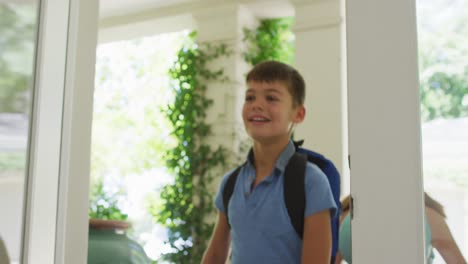 Caucasian-mother-welcoming-happy-son-and-daughter-returning-home,-smiling,-embracing