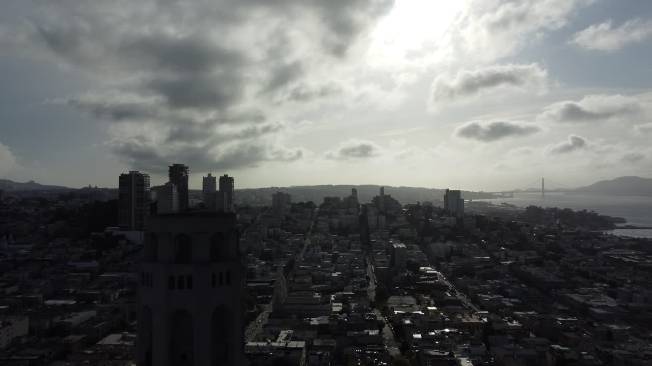 Aerial Sunset Silhouette Of Coit Tower Overlooking The San Francisco Downtown Skyline.