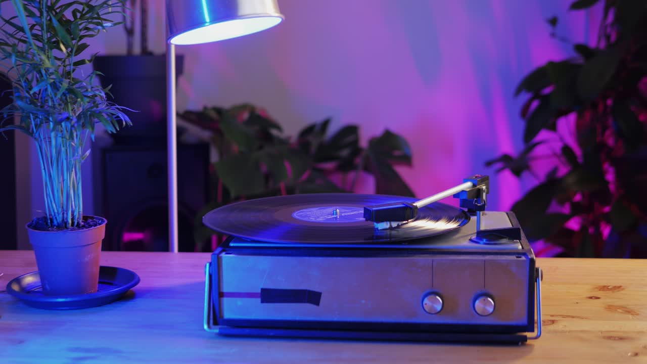 Retro Vinyl record player playing music, close-up macro shot of vintage LP disc old phonograph spinning. Retro music player.