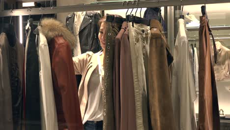 japanese lady choosing clothes in luxury fashion store