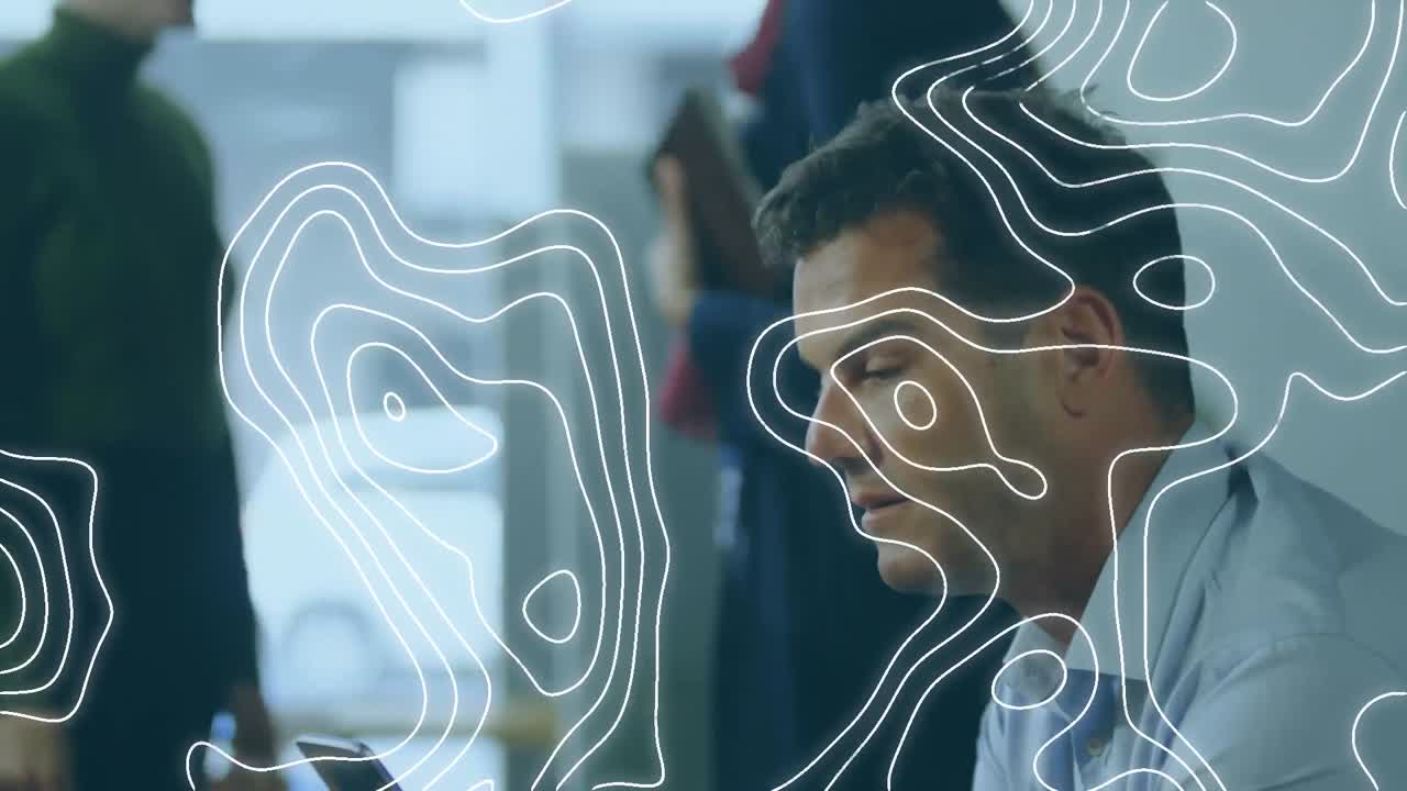 Topography pattern against caucasian businessman using smartphone at office