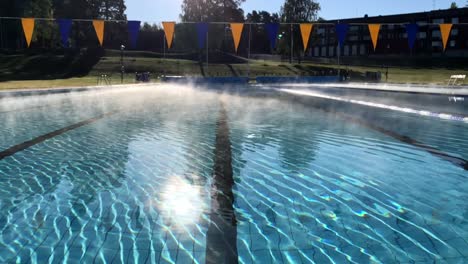 fog from a warm swimming pool meeting cold air on a sunny autumn day