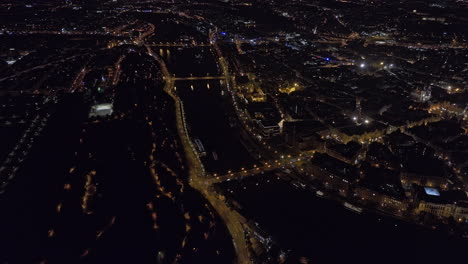 Prague-Czechia-Aerial-v102-high-birds-eye-view,-drone-panning-above-Letna-capturing-illuminated-riverbanks-of-Vltava-river,-night-cityscape-of-Old-and-new-town---Shot-with-Mavic-3-Cine---November-2022