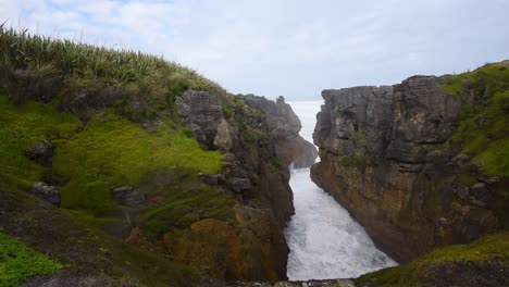 wild waves hitting into cliffs creating a blowhole