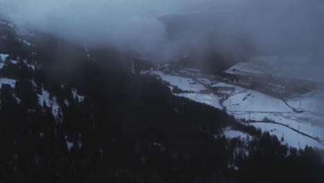 aerial, drone flying through clouds at a pandemic empty ski resort in mountain valley