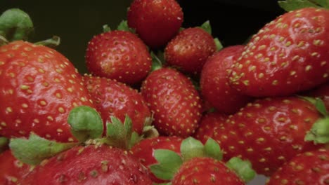 macro slide ripe juicy strawberry. healthy organic food. the camera moves through a heap of strawberries. dolly shot using a probe lens. red berries. close-up. type l.