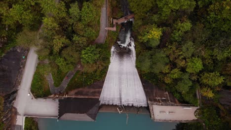 Cascading-Waterfall-From-The-Mountains-And-Lake-Klammsee-In-Austria---aerial-shot