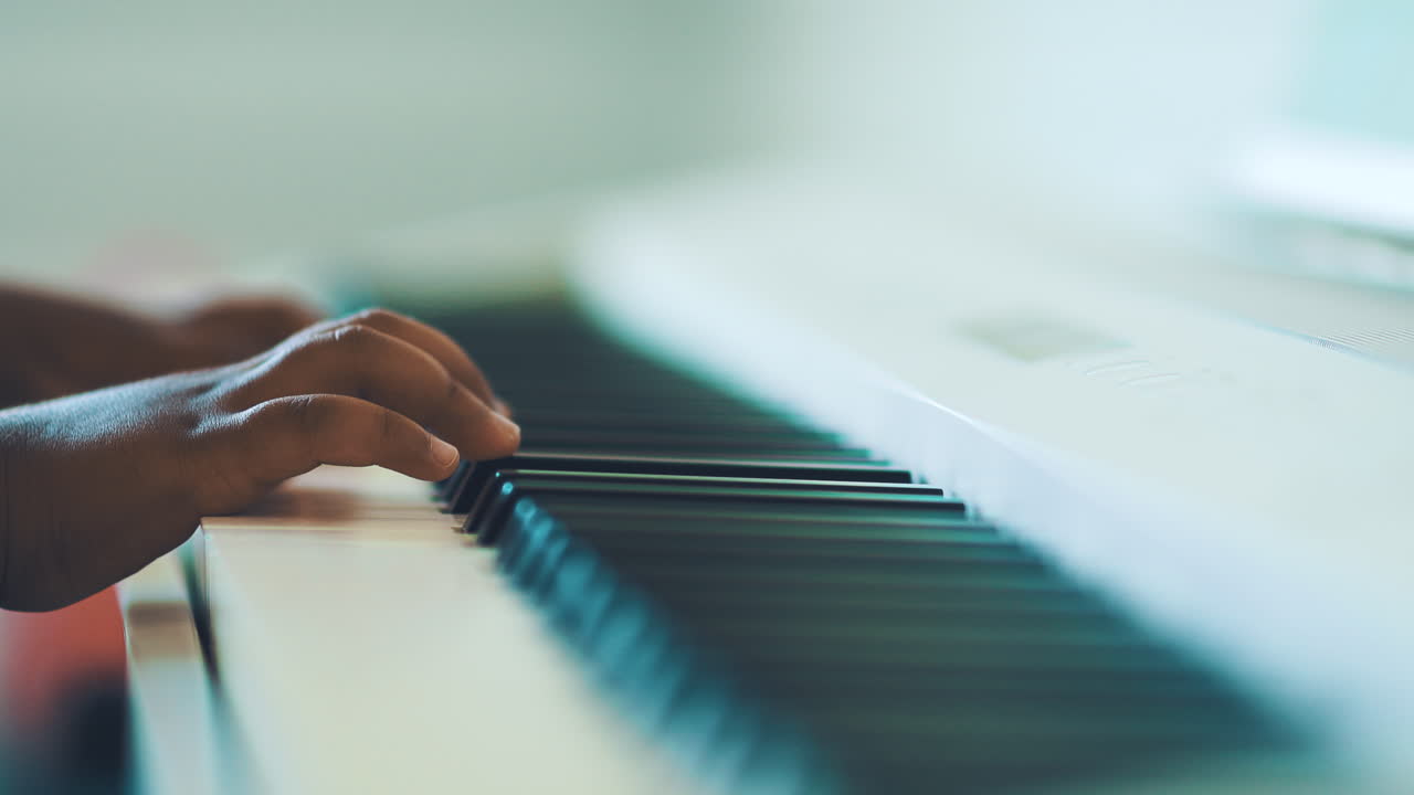 Toddler hands playing a white piano