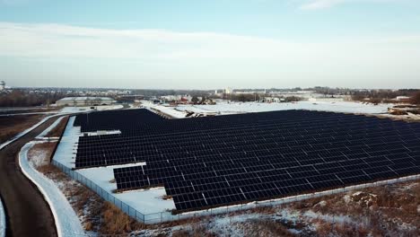 Aerial-drone-flight-of-solar-farm-during-winter-with-snow