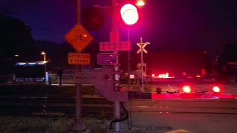 level train crossing tracks at night on road