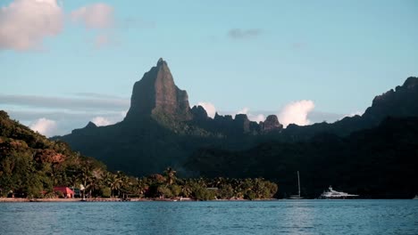 Spectacular-mountain-peaks-of-Moorea-Island-in-French-Polynesia-with-yachts-at-anchor