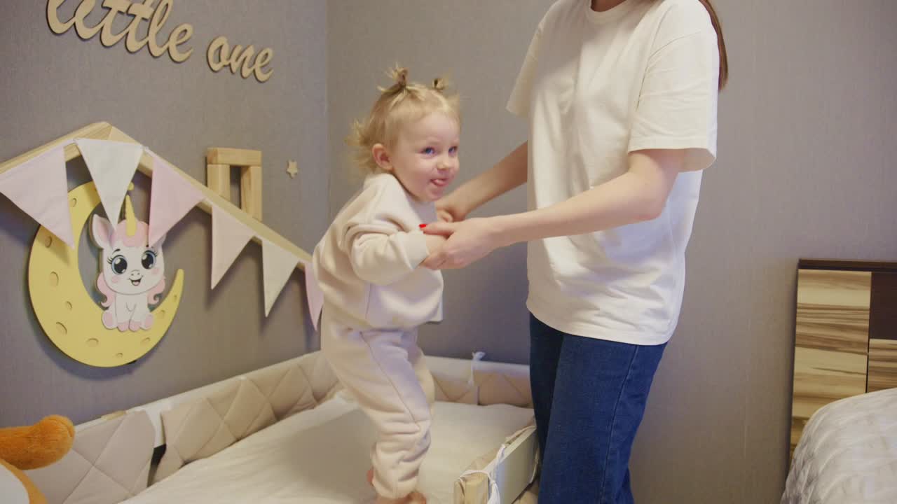 Mother and Baby Playing and Standing in Crib