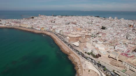 aerial tilt up footage of ancient cadiz cathedral with view of coastal zone and old town, cadiz spain