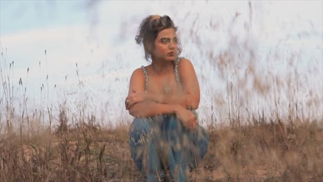 young woman sitting in high grass, early autumn vibe