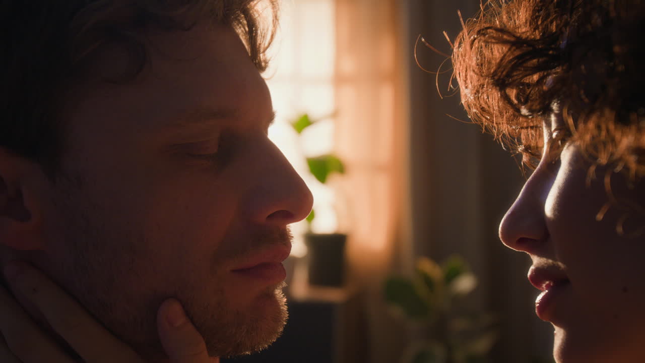 A Romantic Couple Kissing at Sunset