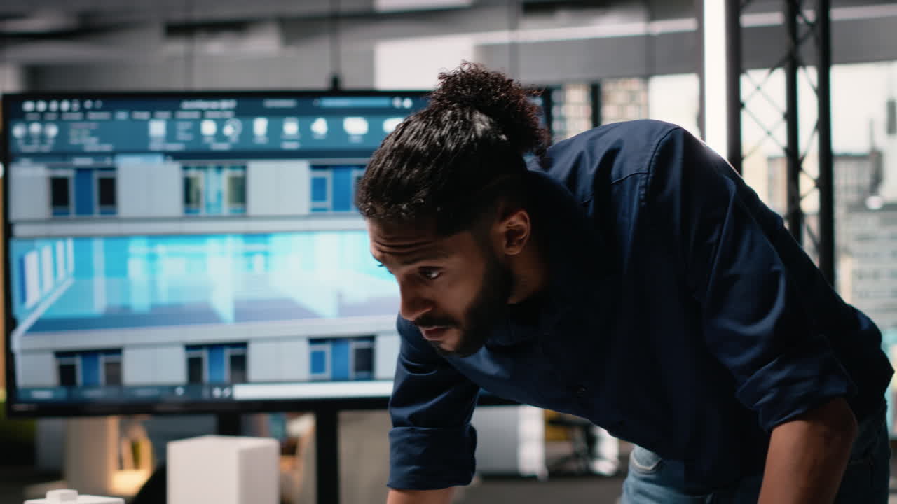 Vertical Video Middle eastern real estate developer evaluates construction site blueprints