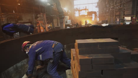 steel plant workers handling refractory bricks