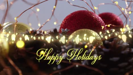 Animation-of-text,-happy-holidays,-in-yellow,-over-string-lights-and-christmas-decorations