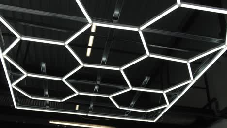 dynamic view of a geometric led lighting installation, common in automotive workshops