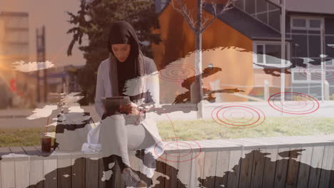 animation of asian woman in hijab using tablet in street over world map