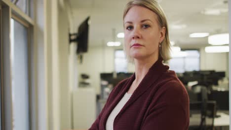 portrait of serious caucasian creative businesswoman looking at camera and smiling