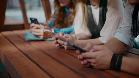 friends using smartphones outdoors