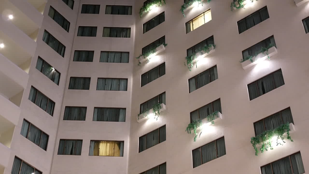 Motion of high rise hotel building inside big shopping mall with 4k resolution