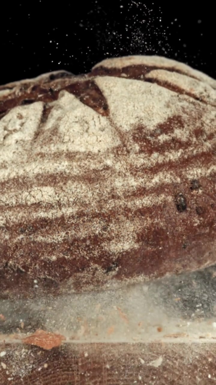 Flour Dust Falling on a Freshly Baked Rustic Rye Bread Loaf