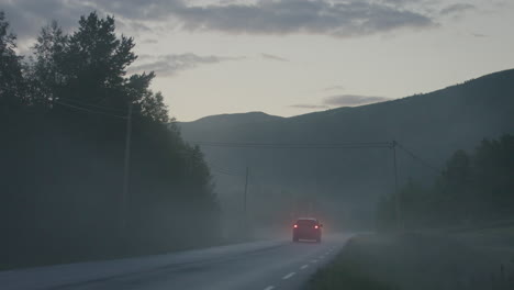 Car-driving-through-fog,-away-from-the-camera