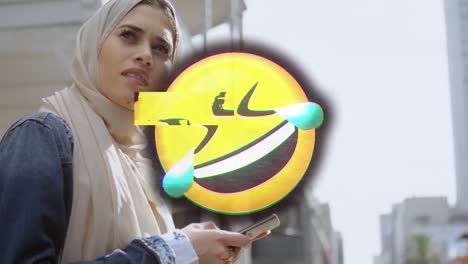 animation of smiling emoji icon over woman in hijab using face mask