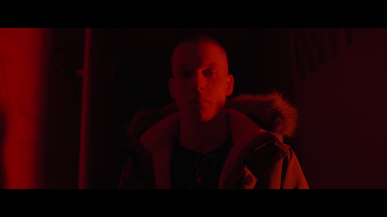 Man in a Red-Lit Urban Setting