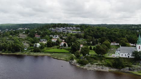 ljungskile residential area, coastal community and lush hillside forest, wide shot, aerial