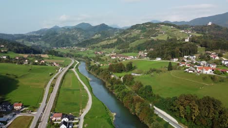 panaromic drone view of river-houses and valley in europe